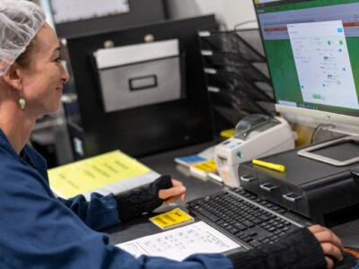 Woman working in Metrc on a desktop computer