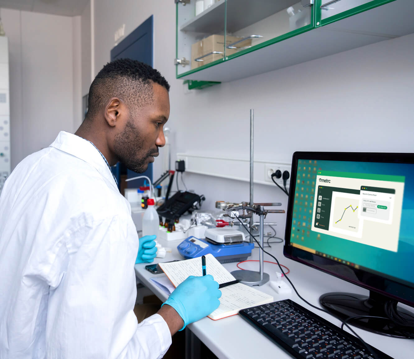 A scientist reading a monitor with data provided by Metrc