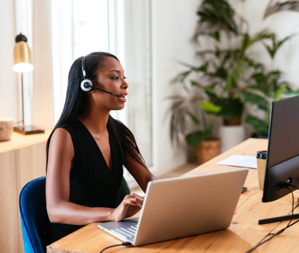 A woman working from home at her kitchen table